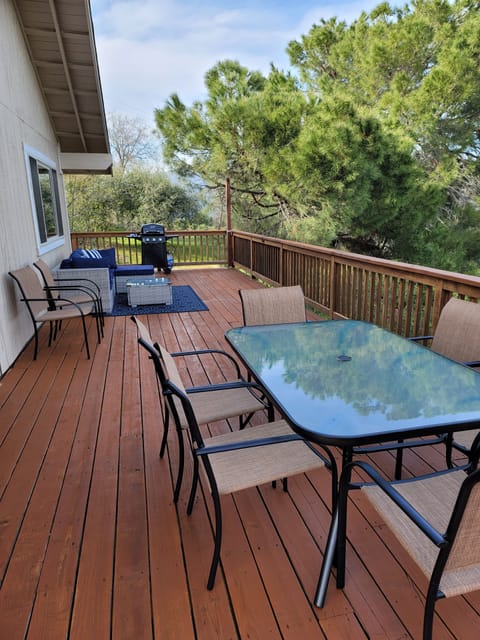 large expansive deck with dining area, lounge area and gas bbq
