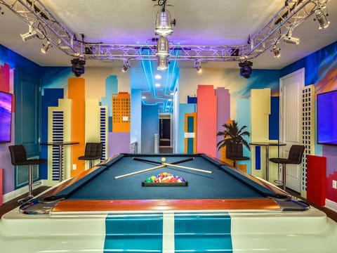 Miami themed game room with Mustang pool table and arcades