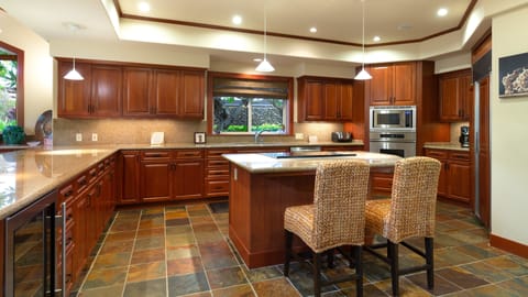 Spacious kitchen stocked with spices, oils and cooking essentials