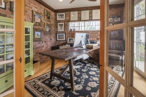 Office with large desk and monitors.
