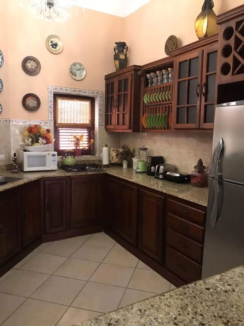 Fridge, stovetop, cookware/dishes/utensils, dining tables