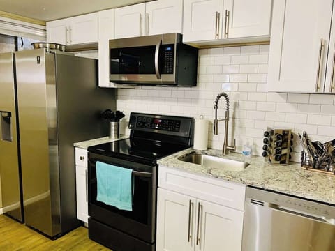 Kitchen fully equipped with appliances, cookware, tableware, cutlery and a stocked Keurig