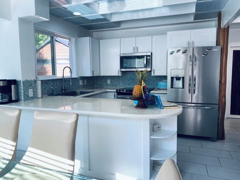 Open Kitchen Concept with Stainless Steel Appliances.