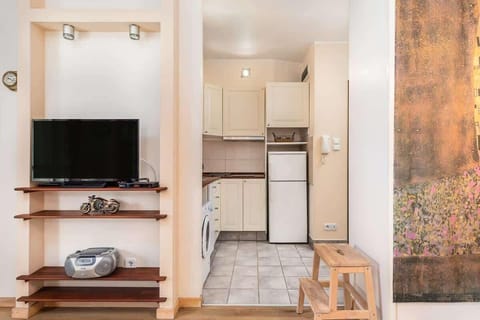 Compact kitchen with all essential appliances, including a washing machine and microwave for convenience.