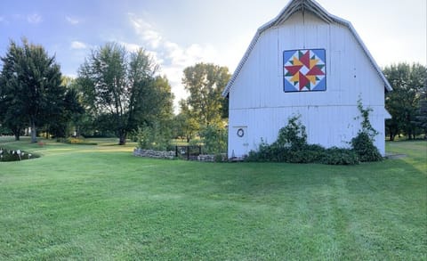 Century hip roof barn with a double aster barn quilt!