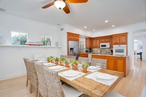 Kitchen wit table seating for 10, fire place and flatscreen TV.