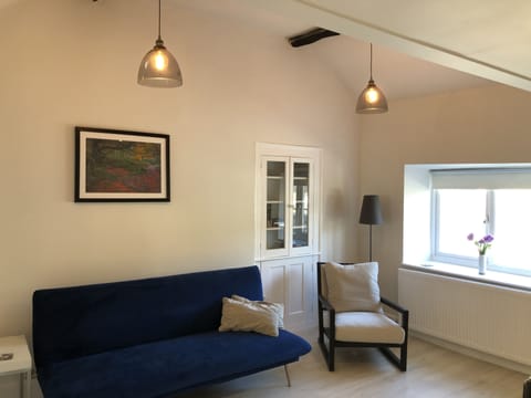 Sitting room, featuring sofabed, TV, seating and dining area