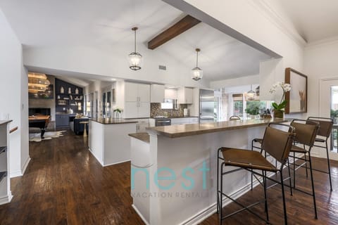 View of the kitchen as you walk from the front door and living room. The Gameroom is in the background.