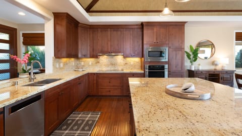 Gourmet kitchen, stocked with spices, oils and cookware essentials