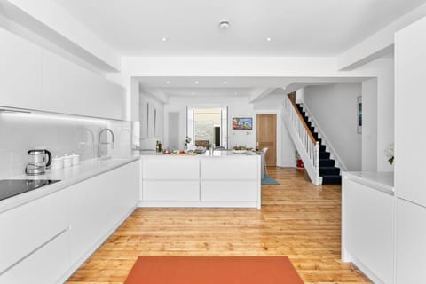 Open-plan kitchen and dining leading to a private, furnished patio.