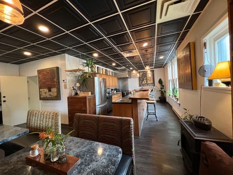 Commercial kitchen with bar stools, diner booths, vintage kitchen table.