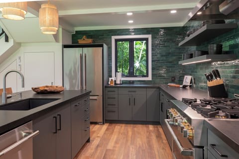 Open-concept kitchen with high-end appliances and ample counter space.