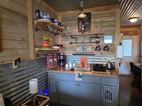 Kitchenette area with coffee and tea pots, mugs, glasses,plates & utensils