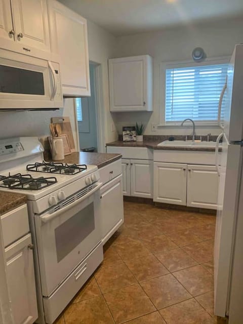 Unique kitchen space - plenty of counter space - refrigerator, microwave, oven, electric stove and all supplies needed for a home cooked meal.