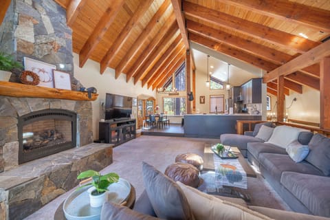 Big family room with custom sectional couch, huge raised ceilings and fireplace