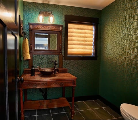 The powder room is adjacent to the mud room and kitchen. 