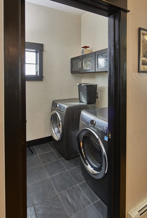 The washer and dryer are available for use. Detergent pods are in cabinet above.