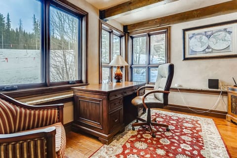 Bright study nook with stunning mountain views, offering a peaceful retreat for work or reading in the comfort of your luxury home.