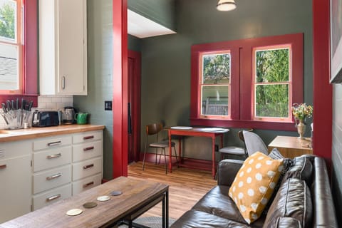 Living area outside of bedroom has high ceilings and natural light