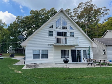 Canal-side view of back patio, firepit, lawn