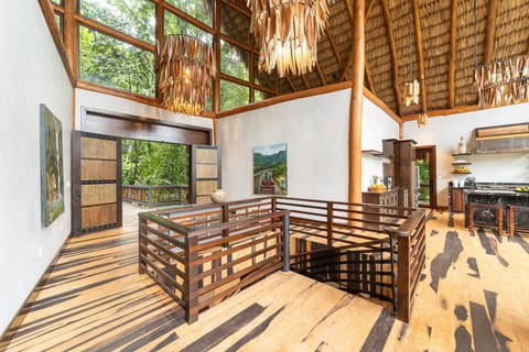 Front door, center staircase, entry foyer, and kitchen (right hand side).