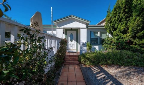 Entrance to our 1949 beach cottage with deck on left and parking on right