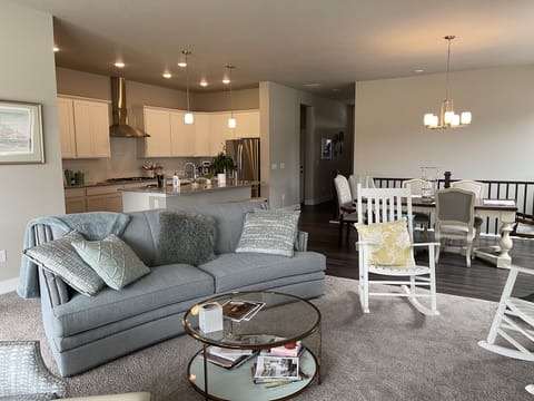 Living room with gas fireplace and three pane slider to outside covered patio