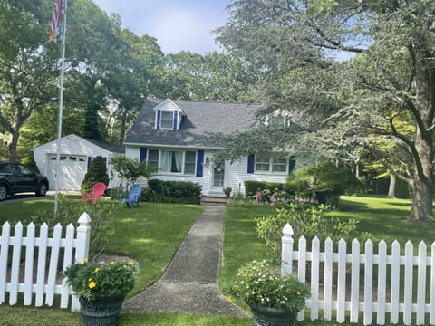 Classic Cape Cod style home- white picket fence and an acre of land to enjoy 