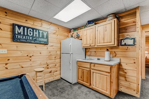 The entertainment game room also has a kitchenette with full sized refrigerator and bar sink.