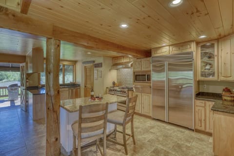 This chef's kitchen features premium appliances and amenities . There's also a gas grill outside.