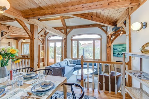 Dining and living area with ample seating, vaulted ceilings, and views of the scenic surroundings