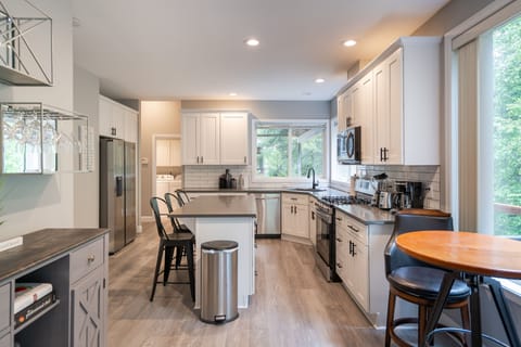 Kitchen with island, pub table and bar counter