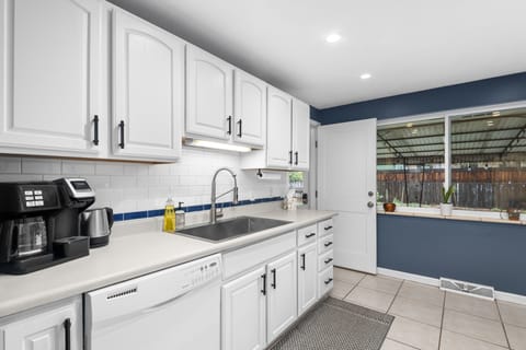 Fully stocked kitchen has a new sink and oven/stove. A drip coffee pot w/ Kureg