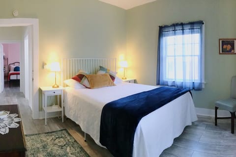 Main Bedroom w/queen bed & dresser (each bedroom has a closet & 2 luggage racks)