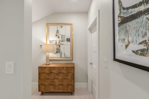 Hall to primary suite with laundry area