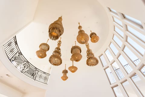 Custom-built hanging chandeliers adorn the high ceilings.