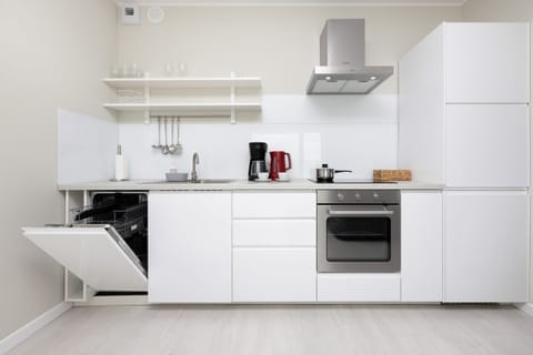 Kitchenette with oven and refrigerator. 