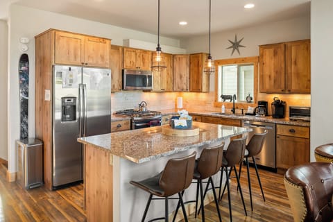 - Modern kitchen with stainless appliances and wood cabinetry - Granite island and bar seating for group dining - Fully equipped vacation rental for mountain getaways