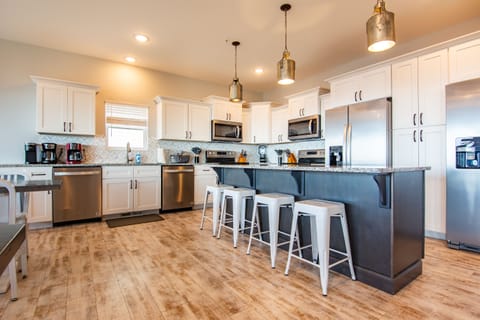 Kitchen with 2 refrigerators, 2 dishwashers, and 2 stoves!