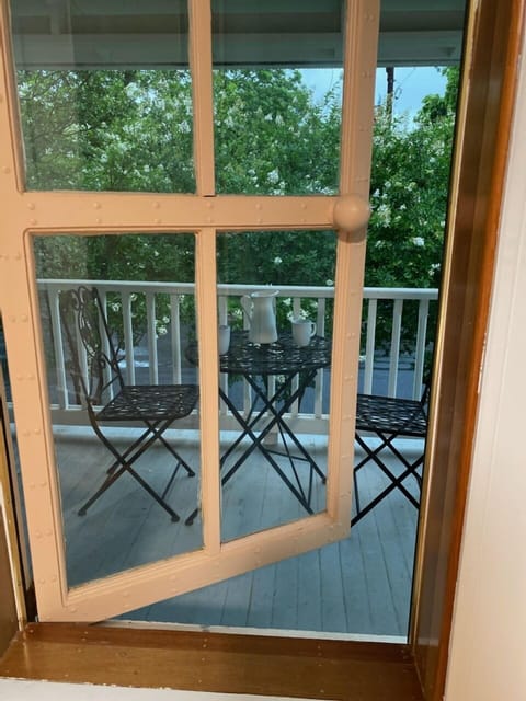 Unique balcony window leads to the smaller balcony facing the front of the house