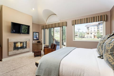 The large windows and balcony in the upstairs king bedroom showcase views of the Snowmass ski area.