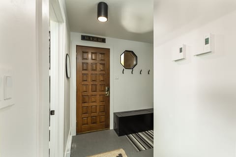 Entry - Entryway with coat hooks and storage seat