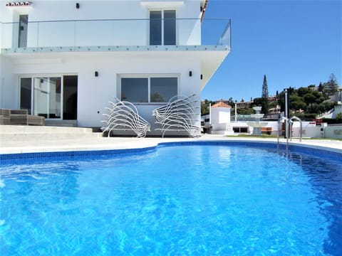 A heated pool, sun loungers