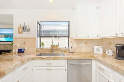 The kitchen has pots, pans, utensils, and dishware for your convenience. 