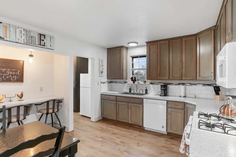 Whip up delicious meals in the fully equipped kitchen, featuring modern appliances, ample counter space, and a charming breakfast bar