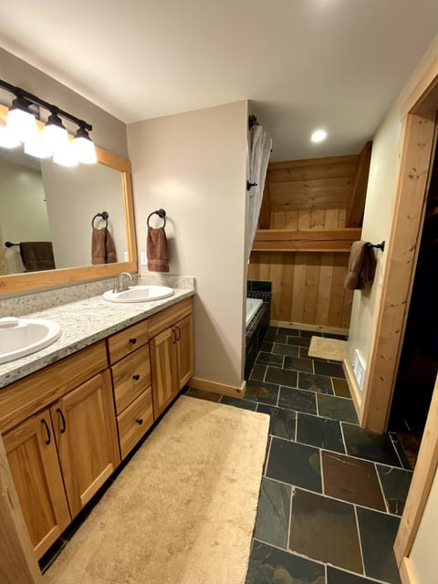Master bathroom with tub, shower, toilet and double sink