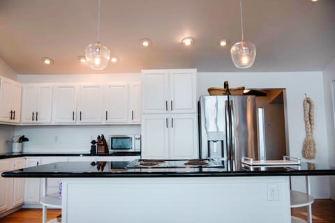 Expansive kitchen with granite countertops and stainless steel appliances.