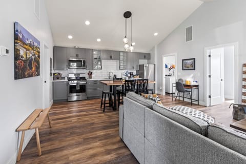 View of kitchen, dedicated workspace, and dining area from the entry to the home