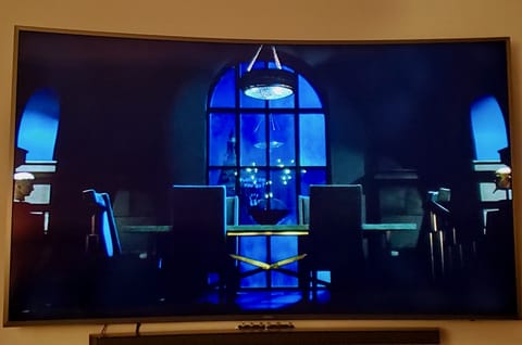 Watch Netflix movies on a half-the-wall screen from the comfort of your bed