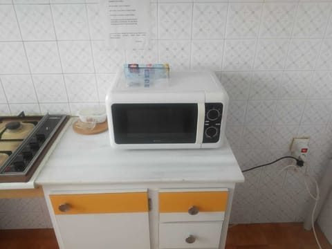 Fridge, microwave, coffee/tea maker, cookware/dishes/utensils